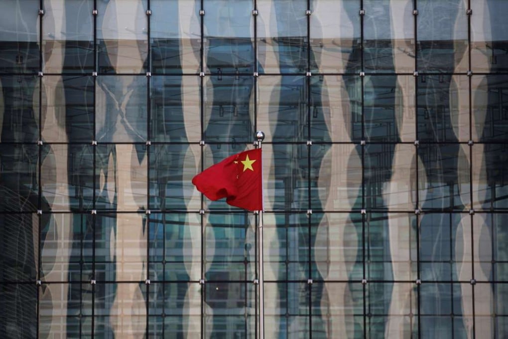 A Chinese national flag flutters at the headquarters of a commercial bank near the headquarters of the People's Bank of China. Photo: Reuters