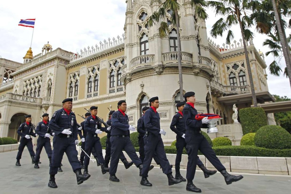 Thai police officers march in front of Government House in Bangkok. Photo: EPA