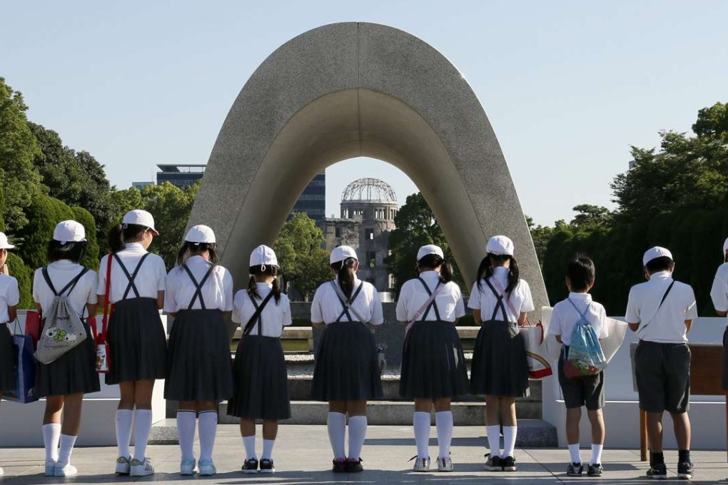 Japanese school children offer prayers for atomic bomb victims at the Hiroshima Peace Memorial. Photo: EPA