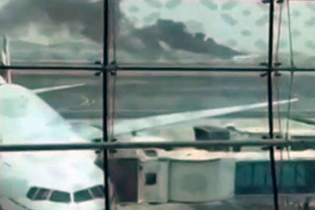 A still picture taken from an amateur video shows smoke rising (at rear) after an Emirates Airline flight crash-landed at Dubai International Airport. Photo: Reuters