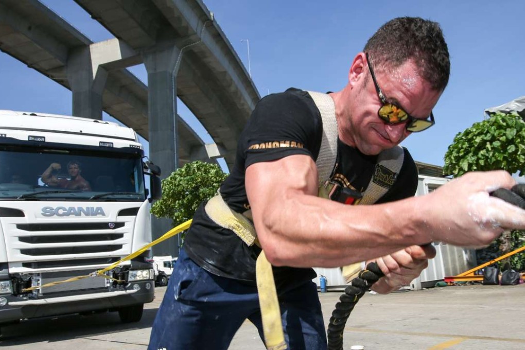 Gary Manwaring pulls an 8.7-tonne truck during a Kwai Chung curtain-raiser to the Arnold Classic Asia Multi-sport Festival. Photo: Edward Wong