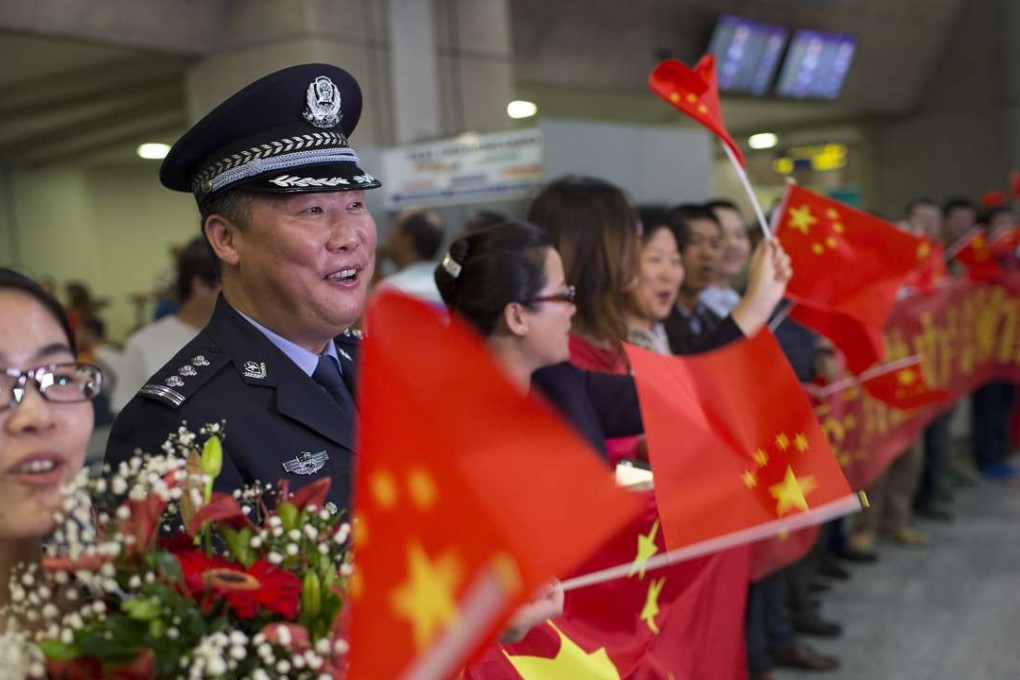 Temporary police communications officer Shao Weimin waits to welcome Chinese athletes to the Rio Olympics at the Rio de Janeiro International Airport on Thursday. Photo: AP