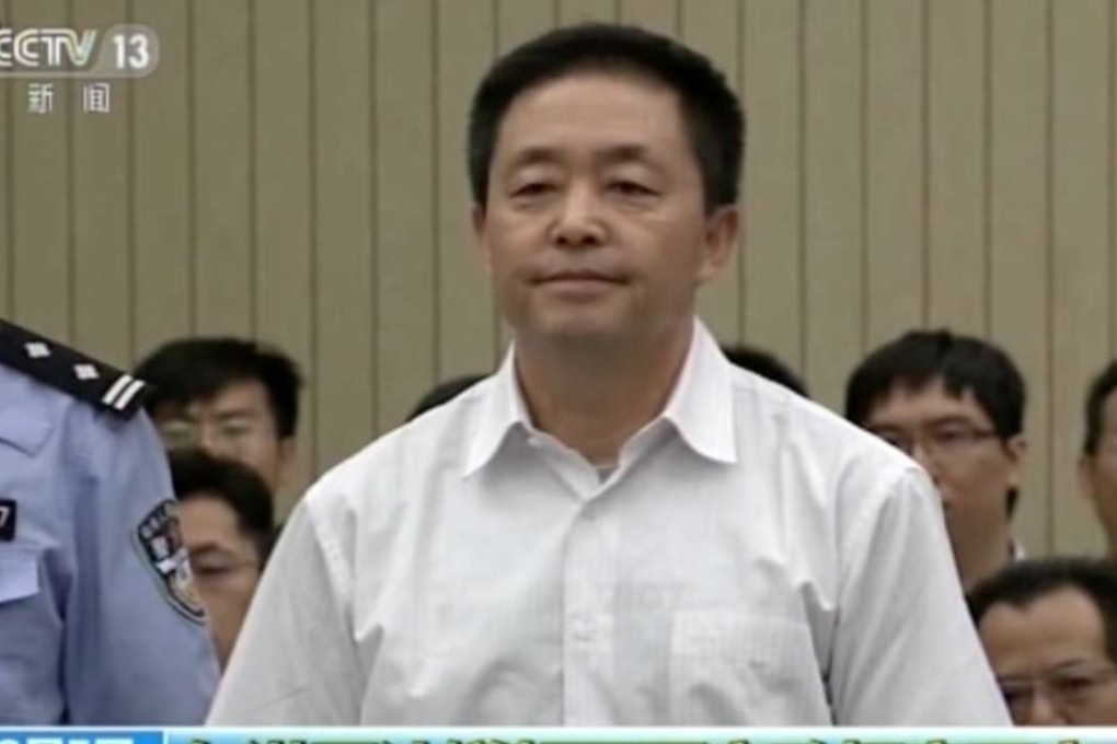 In this image taken from video, human rights activist Gou Hongguo stands trial at the Tianjin No 2 Intermediate People's Court on Friday. Photo: AP