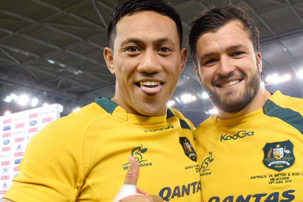 Christian Leali'iano (left) celebrates with team-mate Adam Ashley-Cooper after the Wallabies beat the British & Irish Lions in Melbourne in 2013. Photo: AFP