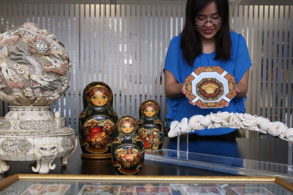 Fiona Fok, Manager of JLA Asia display auction items for former Chief Secretary Rafael Hui Si-yan in Central. Photo: Sam Tsang