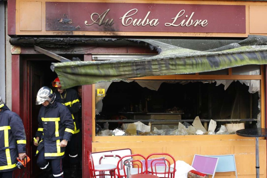 Firefighters leave the bar where a fire broke in Rouen, western France, Saturday Aug.6, 2016. A fire swept through a Friday night birthday party at a bar in the Normandy city of Rouen, killing at least 13 people and injuring six others, French authorities said. (AP Photo/Kamil Zihnioglu)