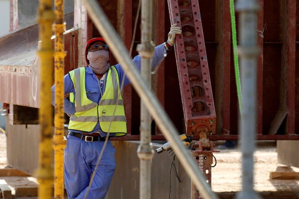 An Asian labourer looks up as he works at a building site in Riyadh. Photo: Reuters