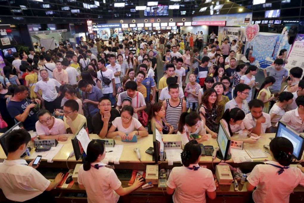 People queue for tickets at a movie theatre in Wuhan. Chinese box-office revenue for the first half of this year grew 21.41 per cent. Photo: Reuters