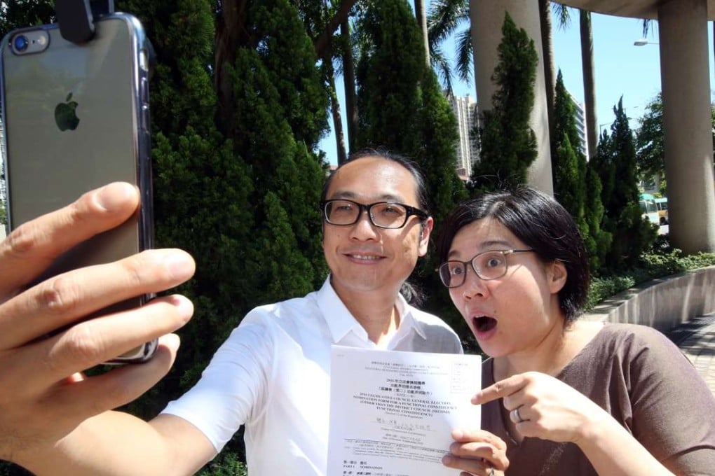 Adrian Chow poses with his wife after submitting his nomination papers in Sha Tin. Photo: Edward Wong