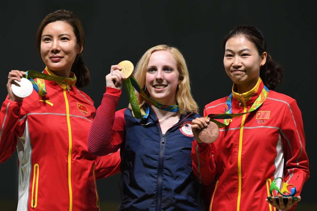 Virginia Thrasher, the US winner of the 10m air rifle, with silver medallist Du Li (left) and bronze medallist Yi Siling, both from China. Photo: AFP