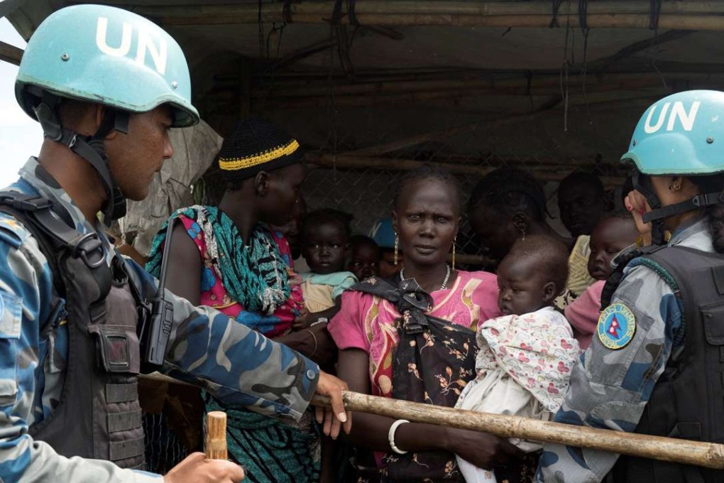 United Nations peacekeepers control South Sudanese women and children before the distribution of emergency food supplies at a UN site in Juba, South Sudan. Photo: Reuters