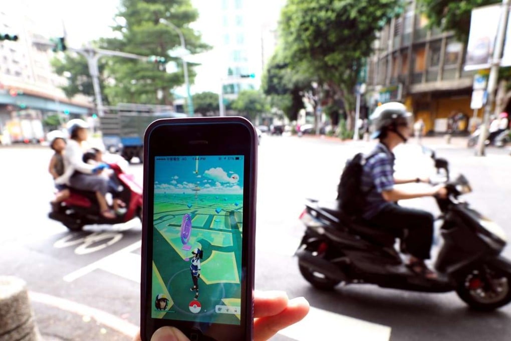 A man playing Pokemon Go on the streets of Taipei on Saturday. Photo: EPA