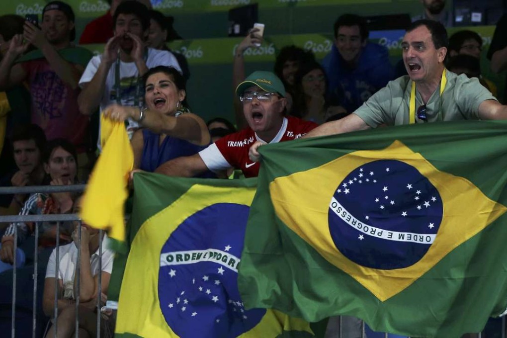 Brazilian fans celebrate after Guilherme Toldo of Brazil wins his match. Photo: Reuters