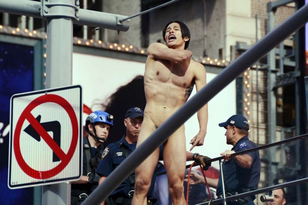In this June 30 photo, Krit McClean shouts before jumping from the ledge above the TKTS Broadway ticket booth in New York's Times Square. Photo: AP