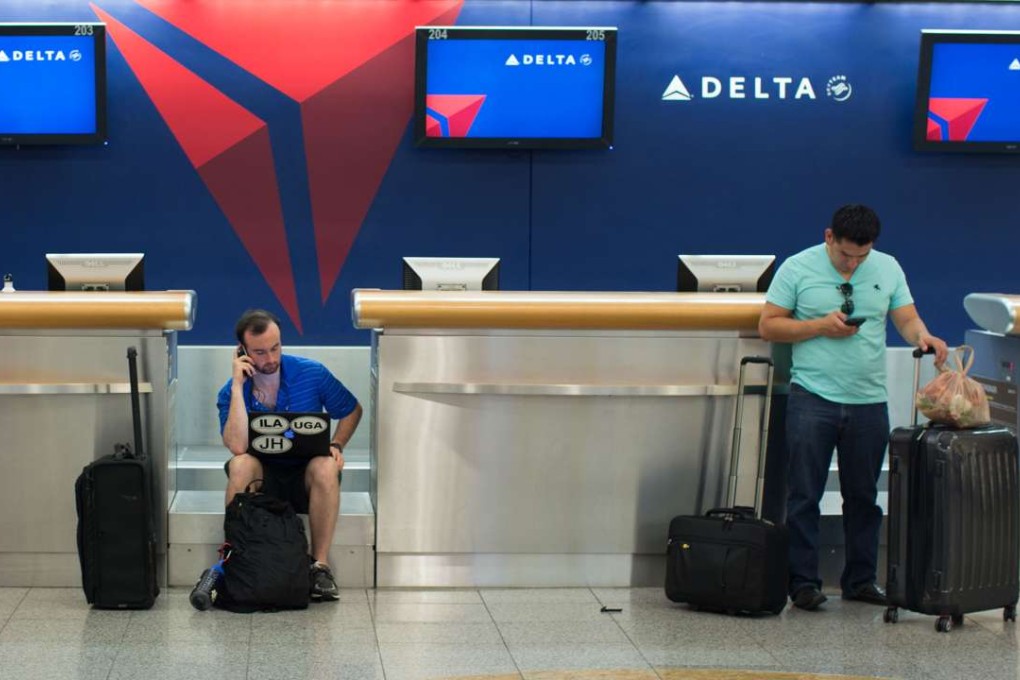 Passengers wait at Hartsfield-Jackson Atlanta International Airport on Monday after Delta Air Lines delayed or cancelled hundreds of flights when its computer systems crashed. Photo: AP