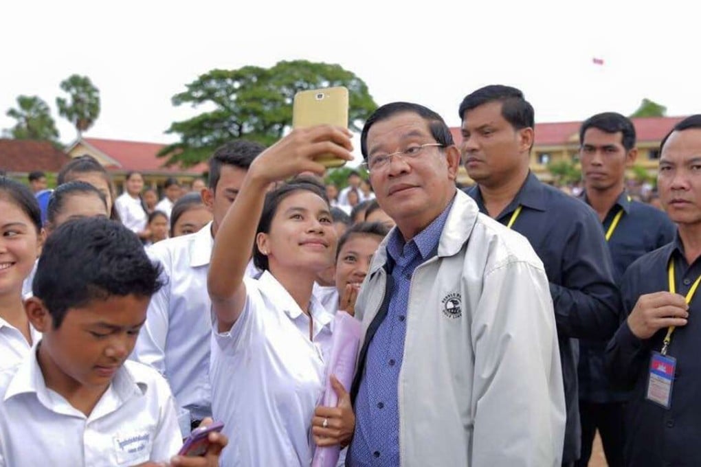 An accessible man of the people? Hun Sen engages young Cambodians in a photo that appears on his Facebook page. Photo: Facebook