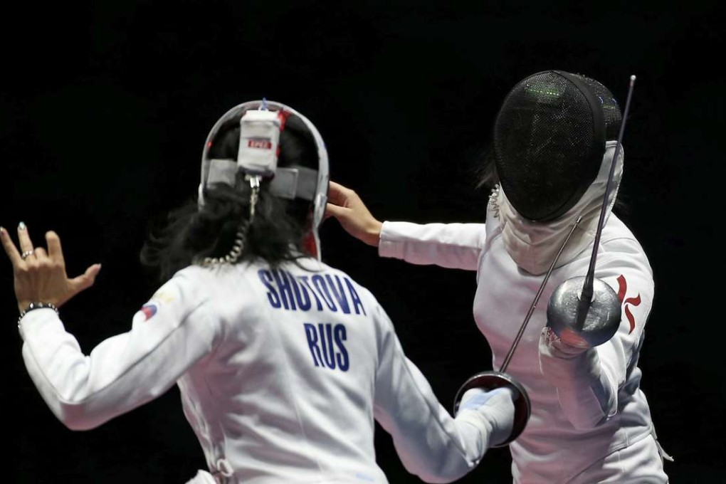 Lyubov Shutova (RUS) of Russia competes with Kong Man Wai (HKG) of Hong Kong. REUTERS/Issei Kato