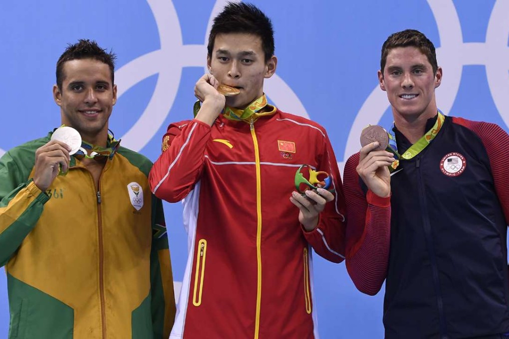 China's Sun Yang (centre) poses with silver medallist Chad Le Clos (left) and bronze medallist Conor Dwyer on the podium after he won the men's 200m freestyle final. Photo: AFP