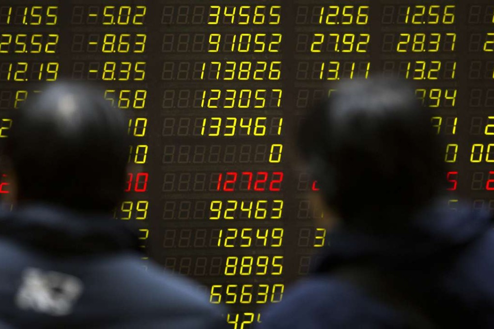 Chinese investors monitor stock prices on an electronic display in a brokerage house in Beijing. The Shanghai Composite Index closing down 0.23 per cent to 3,018.74 on Wednesday, while the Hang Seng Index closed up 0.12 at 22,492.43. Photo: AP