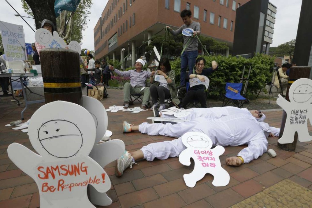 In this May 1, 2016 photo, members of the electronics industry workers advocacy group Banolim perform during a rally against the electronics giant's response to former employees' health concerns on a street in Seoul, South Korea. An Associated Press investigation has found South Korean authorities have, at Samsung’s request, repeatedly withheld crucial information about the chemicals that workers were exposed to at its computer chip and liquid crystal display factories. Workers who have fallen ill due to the chemicals have the right to access such data so they can apply for workers’ compensation from the state. Without this information, government officials commonly reject their cases. (AP Photo/Ahn Young-joon)