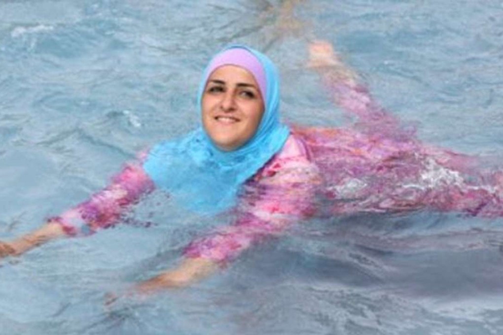 A woman wearing a burqini and swimming in a public pool. Photo: Twitter