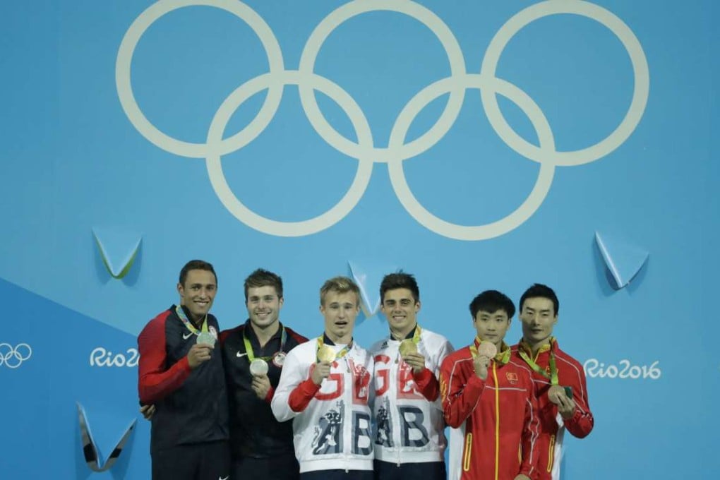 Gold medalists Jack Laugher and Chris Mears of Great Britain pose alongside silver medalists Sam Dorman (L) and Mike Hixon (2nd L) of USA and bronze medalists Cao Yuan 2nd R) and Qin Kai (R) of China. Photo: AP