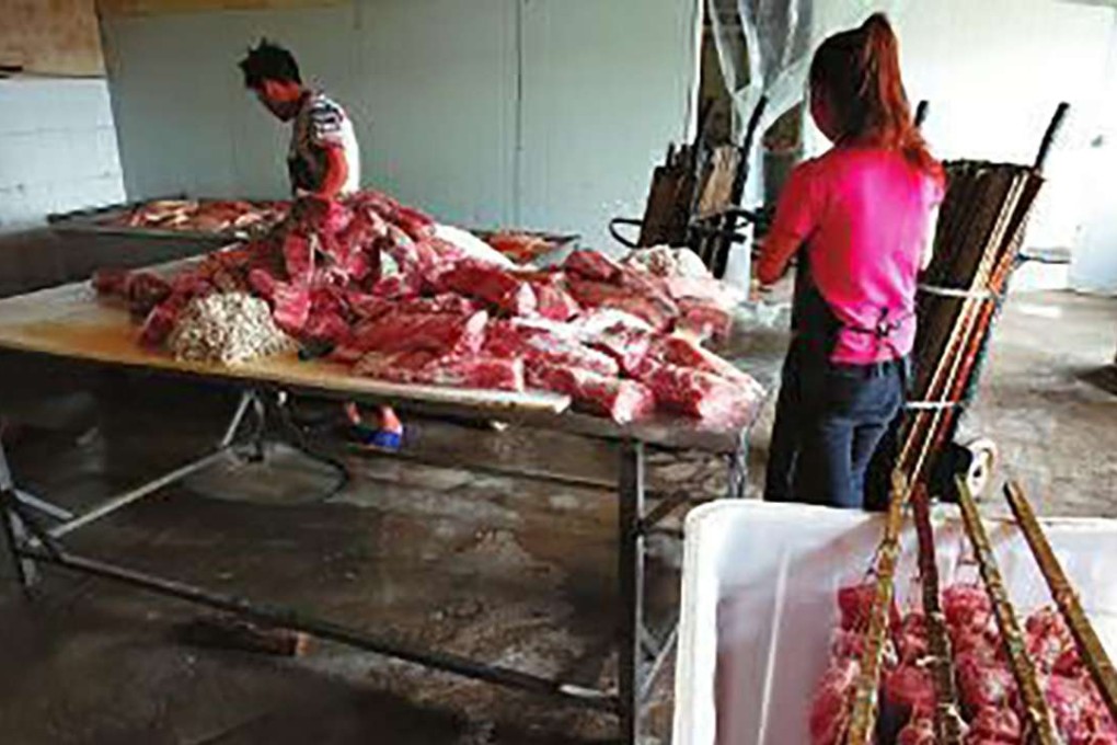 Workers prepare raw meat in the factory. SCMP Pictures (UNDATED HANDOUT)