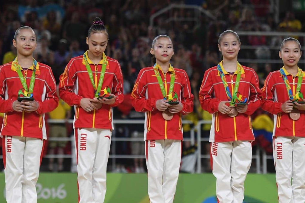 The Chinese team celebrate their bronze medal after the women's artistic gymnastics team final in Rio. Photo: AFP