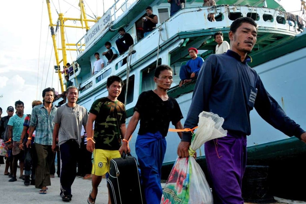 Rescued foreign fishermen are accompanied by Indonesian and Thai officials during an anti-slavery operation in remote Benjina island of Maluku province last year. Photo: AFP