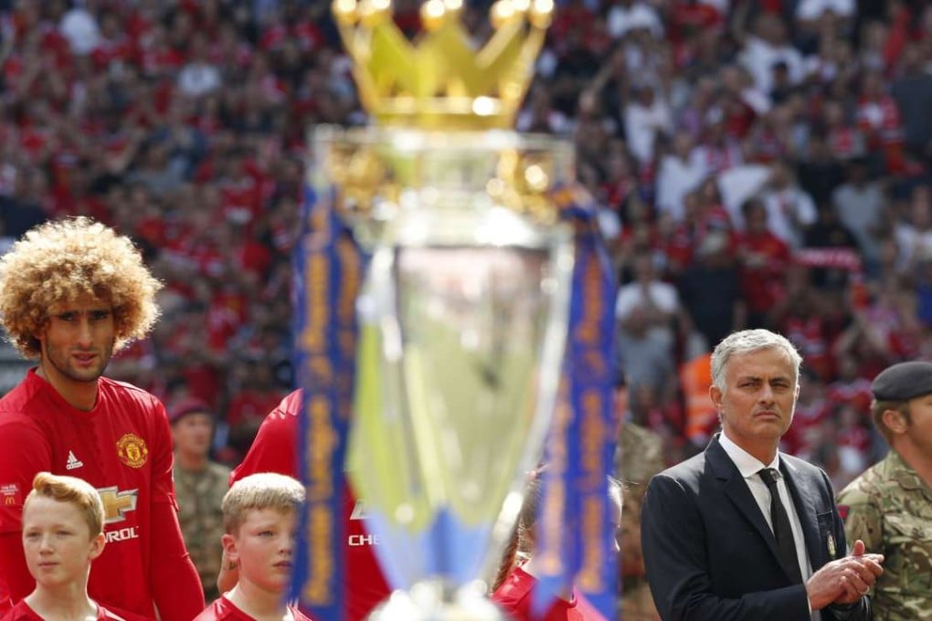 Manchester United manager Jose Mourinho eyes the Premier League trophy before the Community Shield against Leicester City. Photo: Reuters