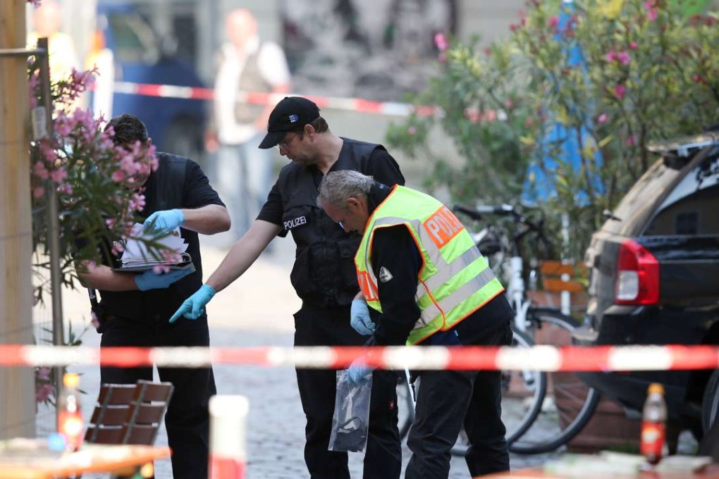 German police investigate the site in Ansbach where a failed asylum seeker from Syria blew himself up and wounded 15 people after being turned away from an open-air music festival. Photo: AP