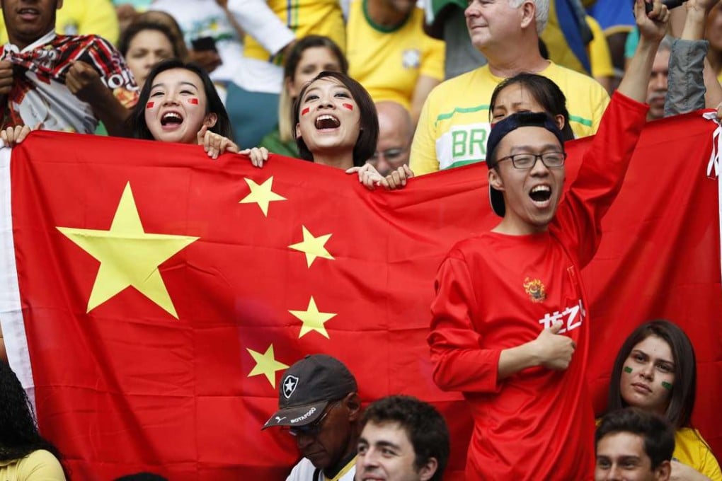 Chinese fans cheer on their team during the women’s first-round match between Brazil and China at the Rio Olympics. Pushed by President Xi Jinping, the Chinese government plans to turn the country into a soccer powerhouse by 2050. Photo: EPA