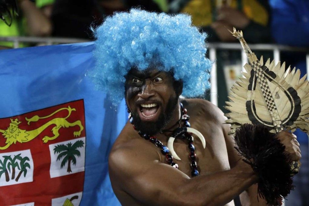 A Fiji fan celebrates his country’s gold medal after a highly successful rugby sevens campaign at the Rio Olympics. Photo: AP