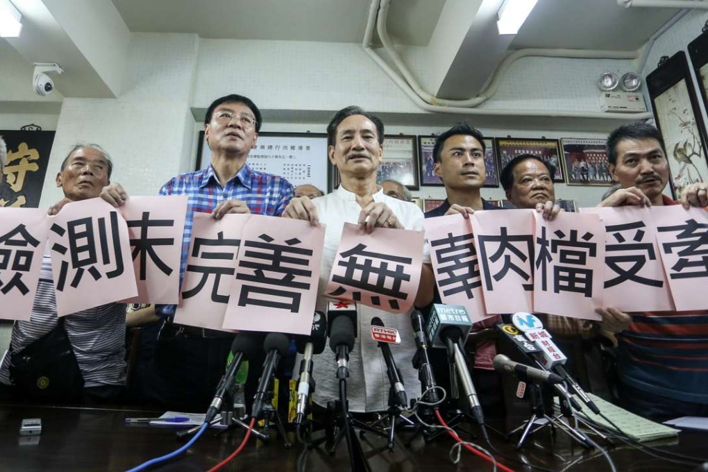 The Pork Traders General Association of Hong Kong disagrees with the plan put forth by the Hong Kong Fresh Meat United group meets the press on the tainted pork in Kennedy Town. Lawmaker Wong Kwok-hing (L2) and Kwok Wai-keung (L5) also attend. Photo: K. Y. Cheng