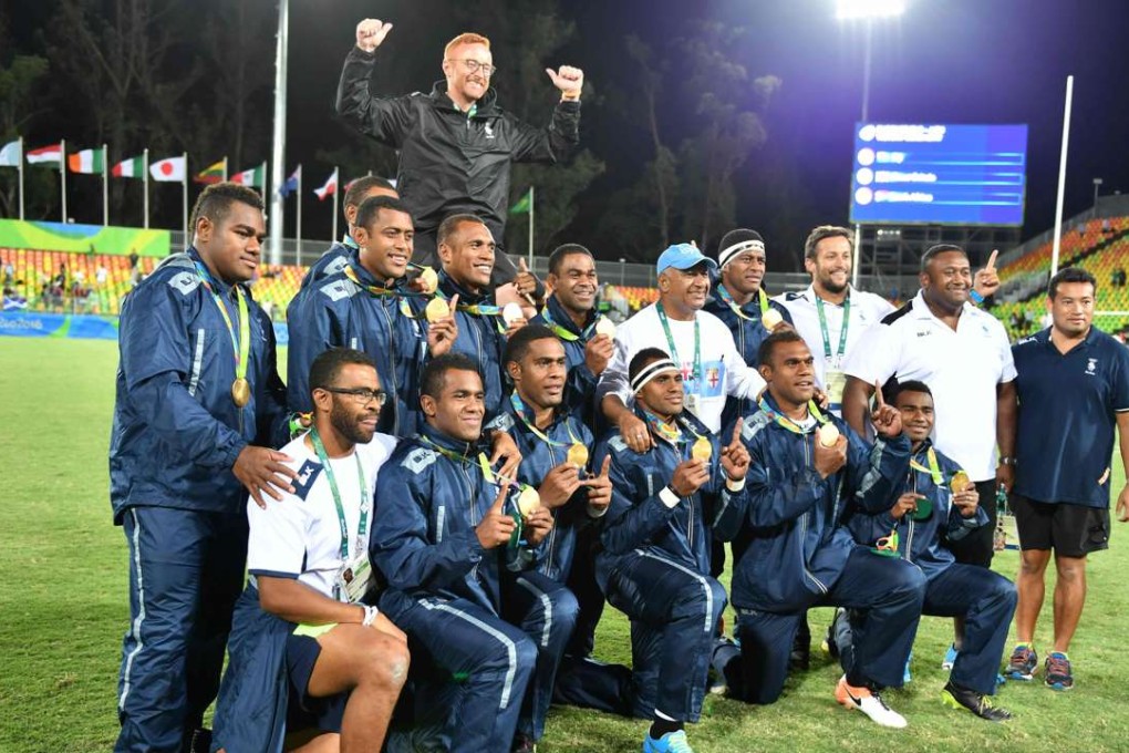 Fiji coach Ben Ryan with his all-conquering team after they claimed the gold medal at the Rio Olympics. Photo: AFP