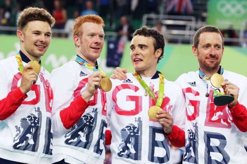 Gold medal winners Owain Doull, Edward Clancy, Steven Burke and Bradley Wiggins pose with their gold medal after Great Britain win the men’s team pursuit in Rio. Photo: EPA