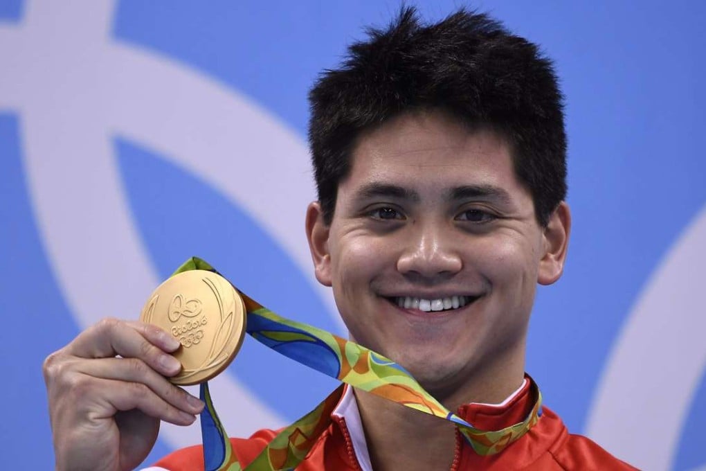 Singapore's Joseph Schooling poses with his gold medal on the podium of the men's 100m butterfly final. Photo: AFP
