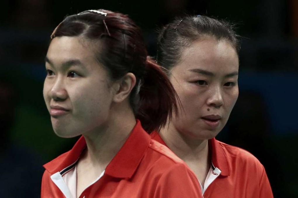 Tie Yana and Lee Ho-ching of Hong Kong look disappointed after Hong Kong are knocked out by Germany. Photo: Reuters