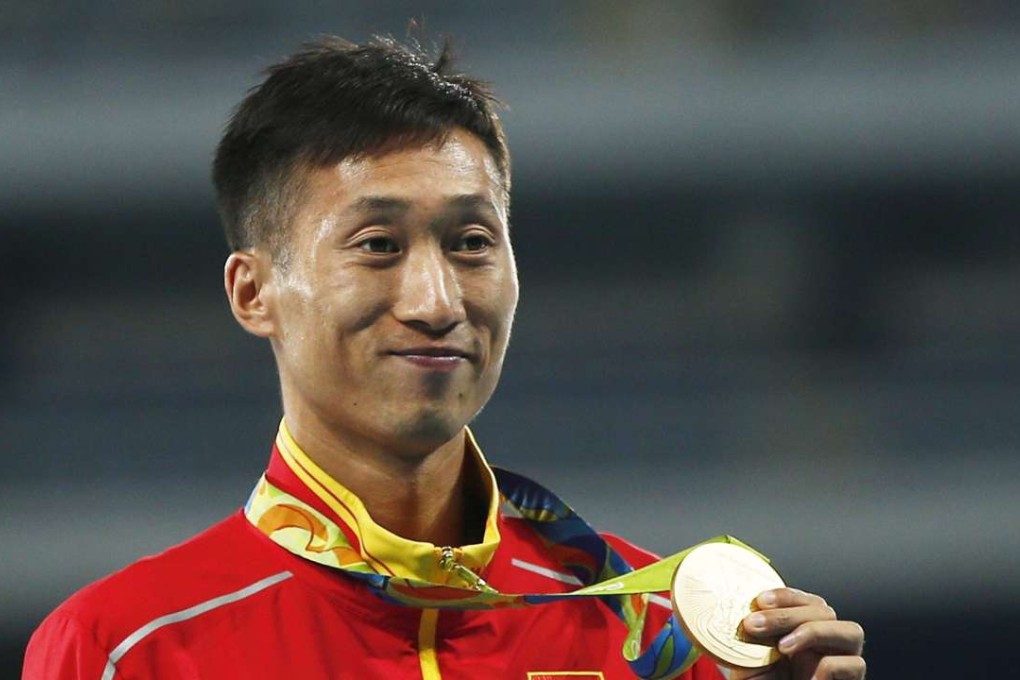 China’s Wang Zhen poses with his gold medal after winning the men’s 20km race walk. Photo: EPA