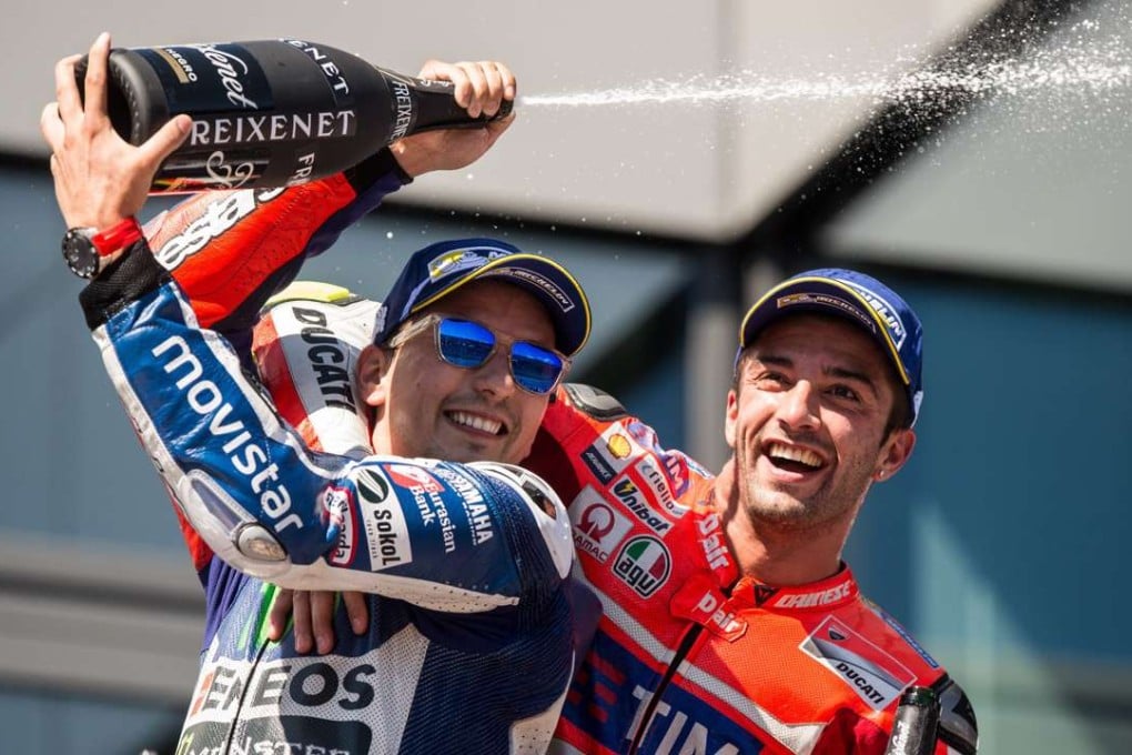 Italian MotoGP rider Andrea Iannone of Ducati (right) and third-placed Spanish ace Jorge Lorenzo of Movistar Yamaha celebrate on the podium at the Austrian Grand Prix. Photo: EPA