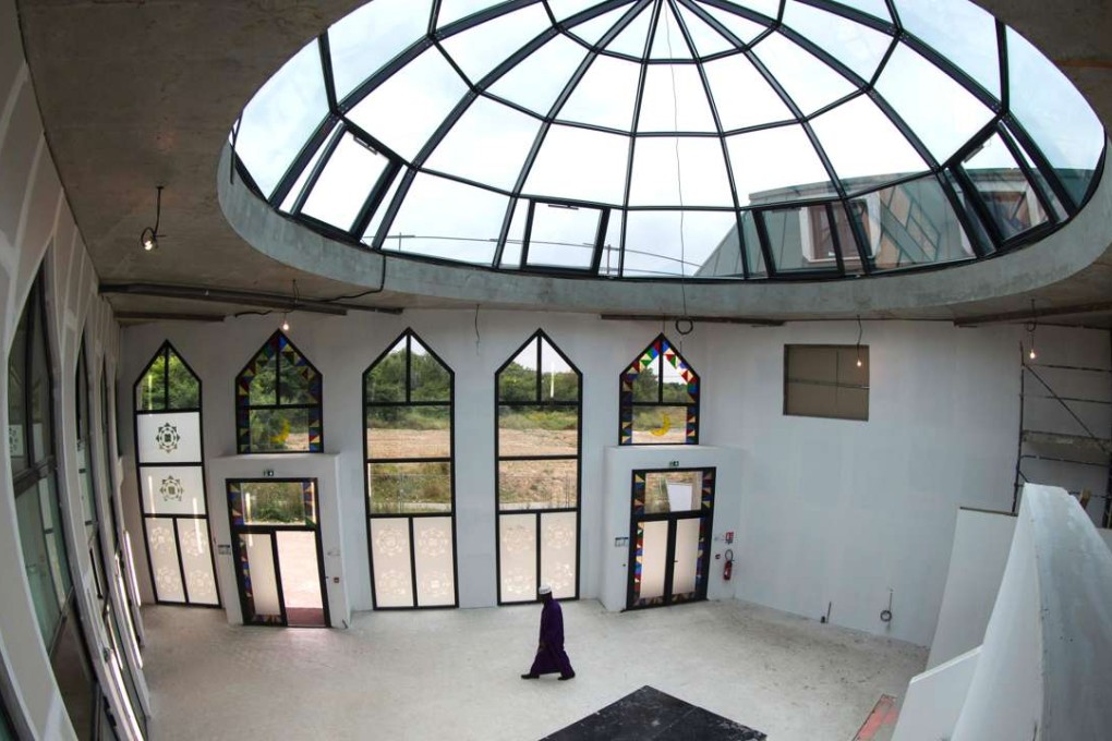A man walks inside the mosque under construction in Grigny, a southern suburb of Paris. Photo: AFP