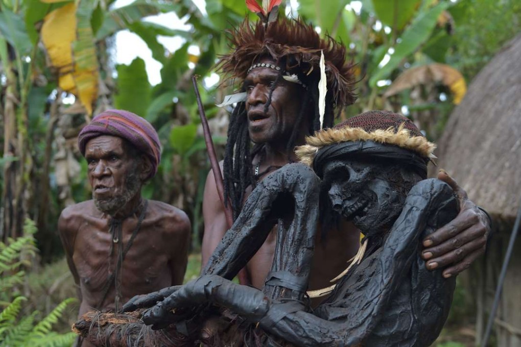 Eli Mabel holds the mummified remains of his ancestor, Agat Mamete Mabel. Photo: AFP