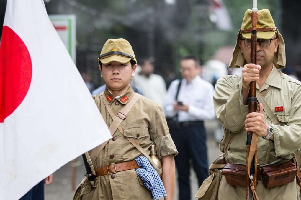 Japanese men wear imperial army costumes at the Yasukuni Shrine in Tokyo. Photo: EPA