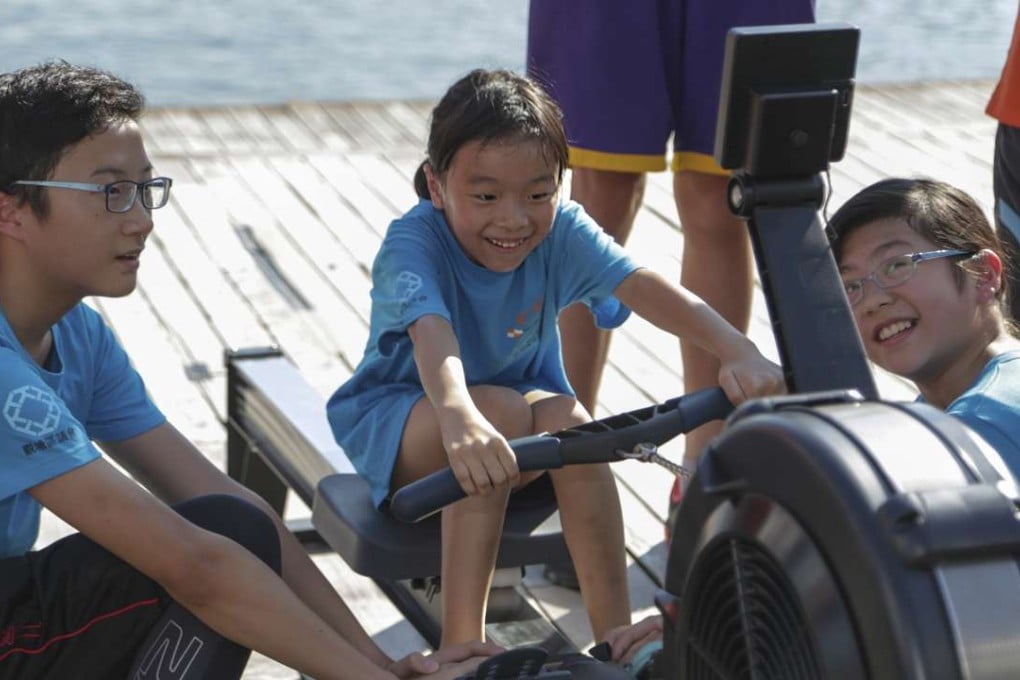 Children participate in a race on a rowing machine during the official inauguration of Kai Tak Youth Rowing Club at Kwun Tong Pier.