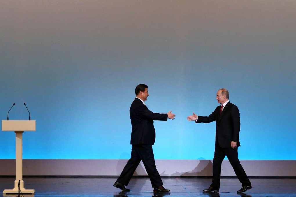 President Xi Jinping (left) is welcomed by Russian counterpart Vladimir Putin at the opening ceremony of "The Year of Chinese Tourism in Russia" in Moscow in March 2013. Photo: AFP