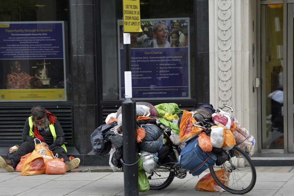 A homeless man sleeps on Pall Mall in London. Photo: Reuters
