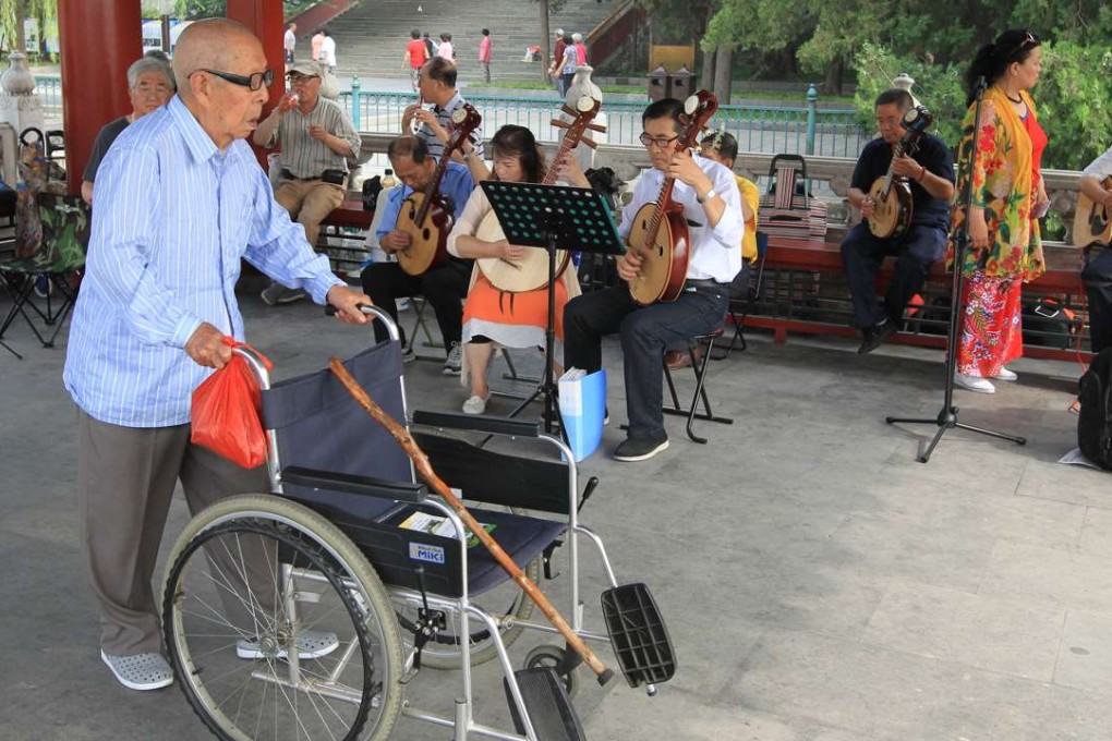 An elderly man pushes his wheelchair in Beihai Park in Beijing. China is projected to have 300 million people aged over 60 in the next decade. Photo: Simon Song