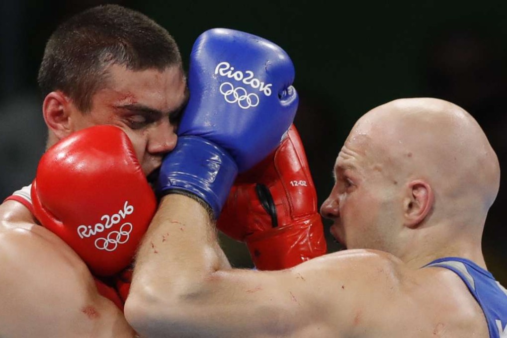 Evgeny Tishchenko of Russia (L) won the Olympic gold but the decision was questioned by a crowd that booed the announcement. Photo: EPA