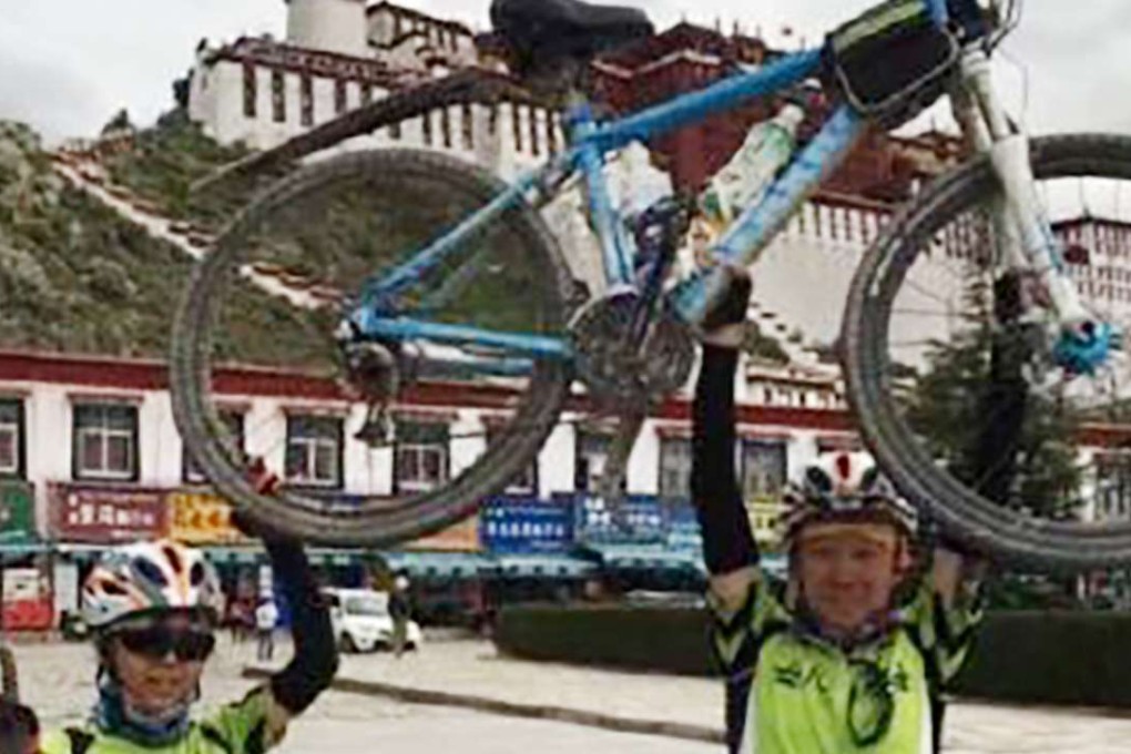 Against the background of the Potala Palace, Li Jinjie and her father, Li Zhao, celebrate their arrival in Lhasa. Photo: SCMP Pictures