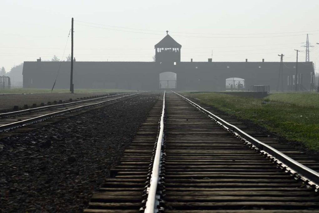 The entrance to the former Nazi German death camp of Birkenau is lit by the morning sun, in Oswiecim, Poland. Photo: AO